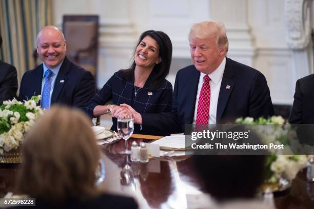 President Donald Trump, sitting next to U.S. Ambassador to the UN Nikki Haley, speaks during a working lunch with ambassadors of countries on the...