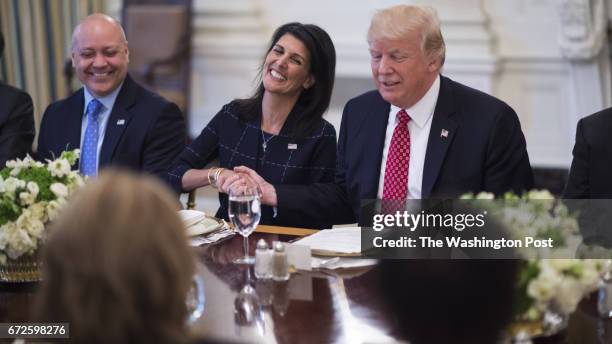 President Donald Trump, sitting next to U.S. Ambassador to the UN Nikki Haley, speaks during a working lunch with ambassadors of countries on the...