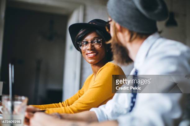 candid couple dating in a coffee shop - hipster coffee shop candid stock pictures, royalty-free photos & images