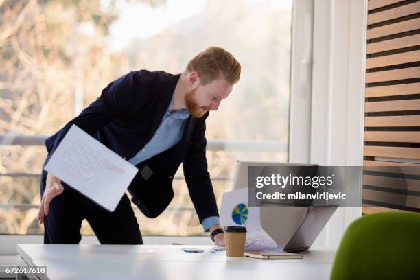 angry businessman throwing papers while searching the right one - cluster headache stock pictures, royalty-free photos & images