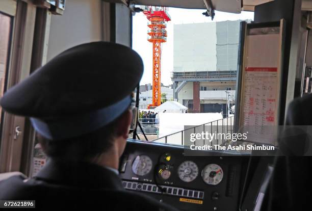 Train runs past the accident site on the twelveth anniversary of the train derailment accident on April 25, 2017 in Amagasaki, Hyogo, Japan. The...