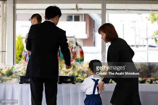 Bereaved family members offer payers at an altar during the memorial ceremony on the twelveth anniversary of the train derailment accident on April...
