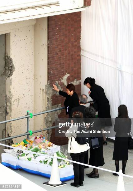 Bereaved family members visit the wall of the apartment building on the twelveth anniversary of the train derailment accident on April 25, 2017 in...