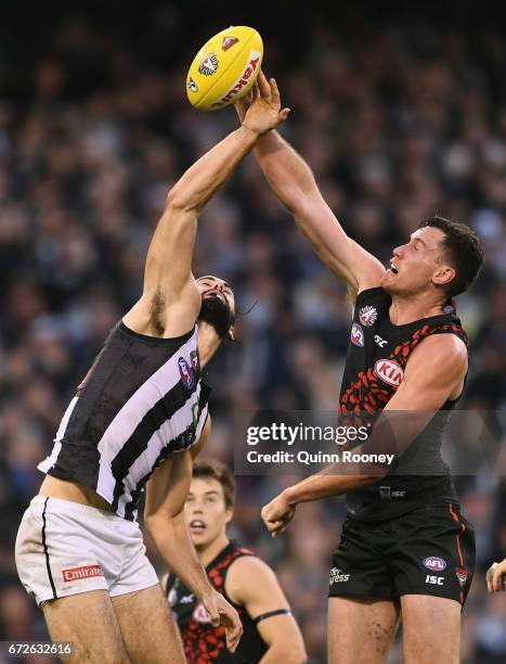 Brodie Grundy of the Magpies and Matthew Leuenberger of the Bombers compete in the ruck during the round five AFL match between the Essendon Bombers...