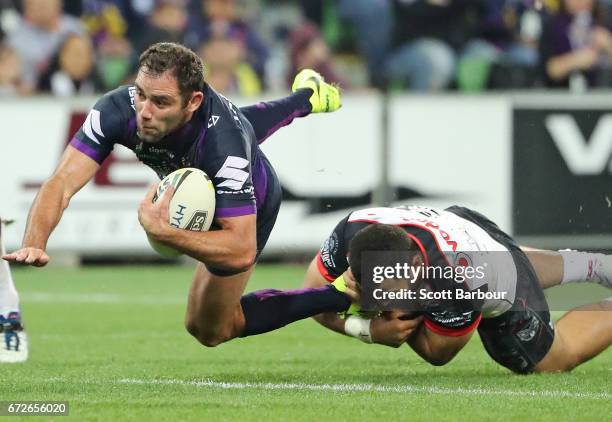 Cameron Smith of the Melbourne Storm is tackled during the round eight NRL match between the Melbourne Storm and the New Zealand Warriors at AAMI...