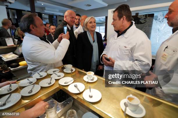 French presidential election candidate for the far-right Front National party, Marine Le Pen , flanked by her bodyguard Thierry Legier , meets...