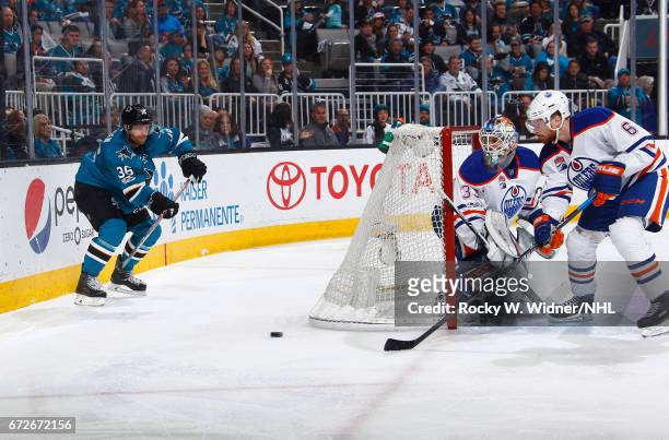 Cam Talbot and Adam Larsson of the Edmonton Oilers defend the net against Jannik Hansen of the San Jose Sharks in Game Six of the Western Conference...