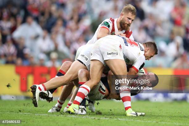 Boyd Cordner of the Roosters is tackled by Jack de Belin, Cameron McInnes and Tariq Sims of the Dragons during the round eight NRL match between the...