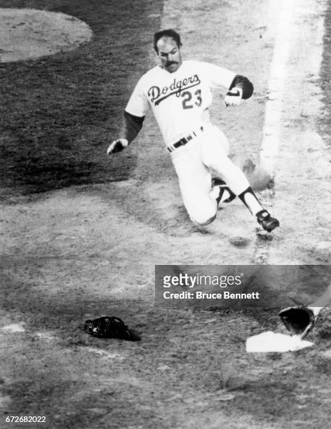 Kirk Gibson of the Los Angeles Dodgers slides into home plate during an MLB game circa 1988 at Dodger Stadium in Los Angeles, California.