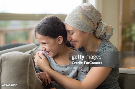 Ethnic young mom with cancer holding daughter Ethnic young mom with cancer holding daughter