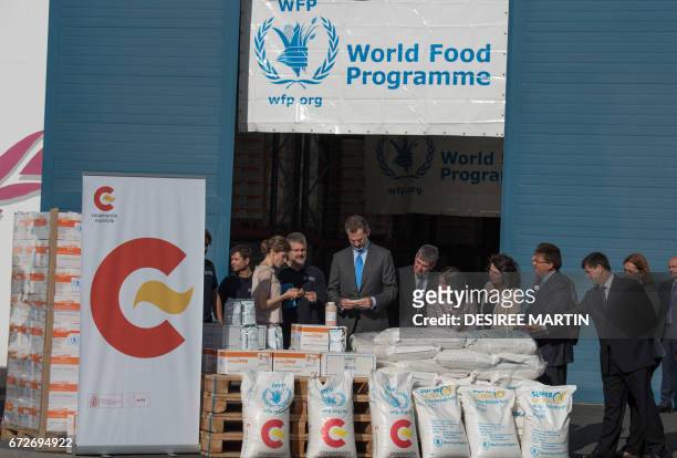Spain's King Felipe VI and Spain's Queen Letizia stand during a visit to the facilities of the World Food Program Center on the Spanish Canary Island...