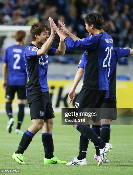Japan's Gamba Osaka midfielder Ritsu Doan celebrates his goal with teammate Shun Nagasawa during the AFC Champions League football match against...