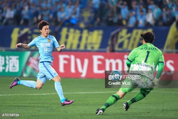 Kim Ho-jun of Jeju United tries to stop the ball as Xie Pengfei of Jiangsu Suning kicks during 2017 AFC Champions League group match between Jiangsu...