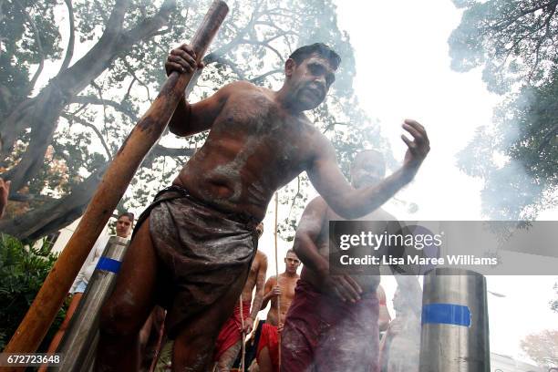 Indigenous man takes part in a traditional smoking ceremony during the ANZAC service at Redfern Park on April 25, 2017 in Sydney, Australia. The...