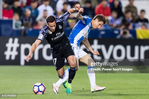 Lucas Vazquez of Real Madrid competes for the ball with Alexander Szymanowski of Deportivo Leganes during their La Liga match between Deportivo...