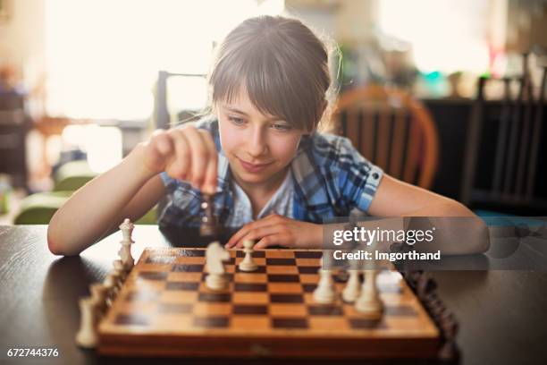 teeange girl playing game of chess - chess stock pictures, royalty-free photos & images