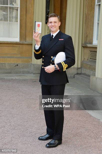 Lieutenant Peter Reed poses after he was awarded an MBE for services to rowing by the Princess Royal during an Investiture ceremony at Buckingham...