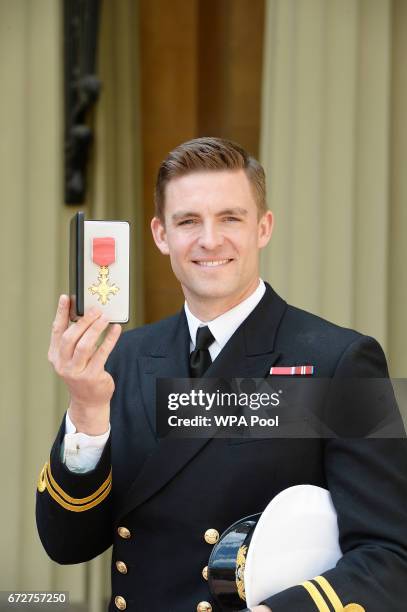 Lieutenant Peter Reed poses after he was awarded an MBE for services to rowing by the Princess Royal during an Investiture ceremony at Buckingham...