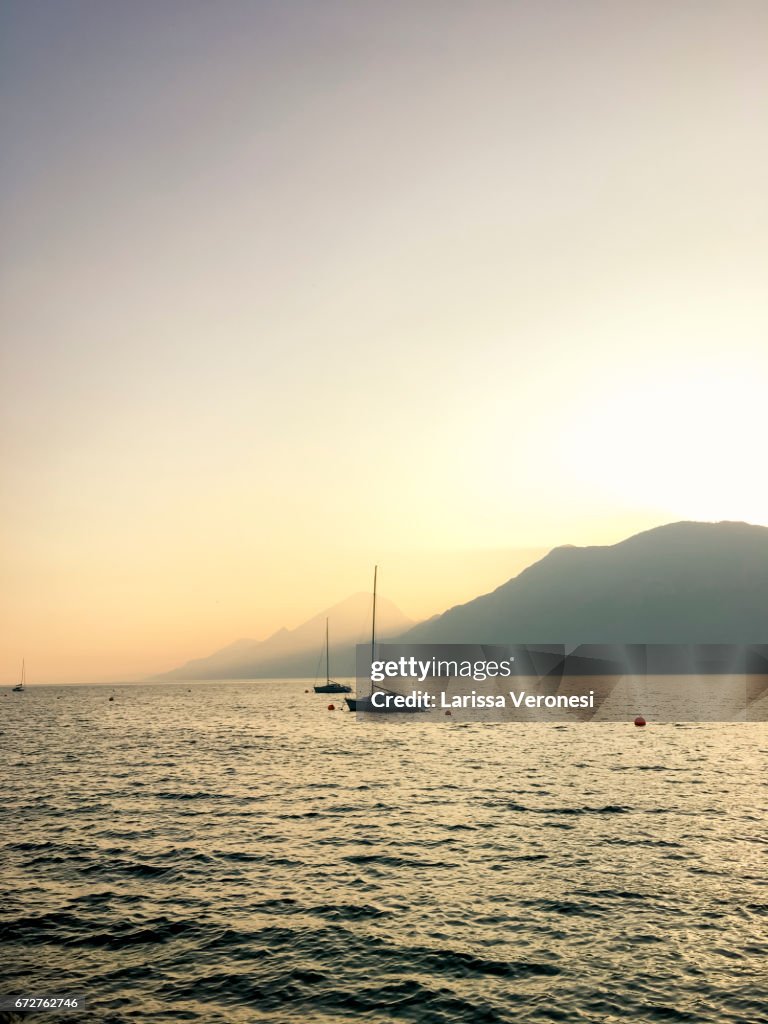 View of Lake Garda with Sailboats at sunset, Brenzone Sul Garda