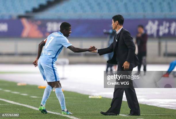 Ramires and head coach Choi Yong-soo of Jiangsu Suning touch hands during 2017 AFC Champions League group match between Jiangsu Suning F.C. And Jeju...