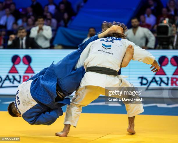 Hidayat Heydarov of of Azerbaijan is subjected to a second unsuccessful 'flying juji-gatame ' attack by Dmytro Kanivets of Ukraine in their u73kg...