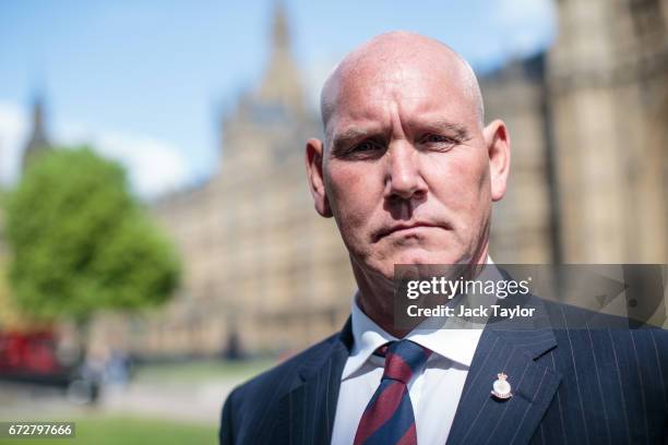 Survivor of the 1982 IRA Hyde Park bomb attack Simon Utley poses for a photograph in front of the Houses of Parliament on April 25, 2017 in London,...