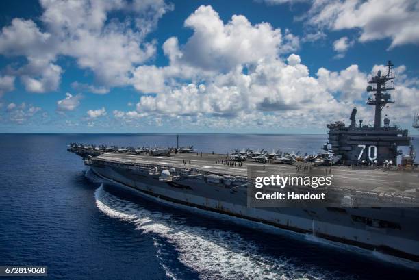 In this photo provided by the U.S. Navy, the USS Carl Vinson transits the Philippine Sea while conducting a bilateral exercise with the Japan...