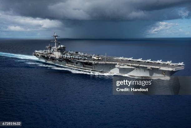 In this photo provided by the U.S. Navy, the USS Carl Vinson transits the Philippine Sea while conducting a bilateral exercise with the Japan...