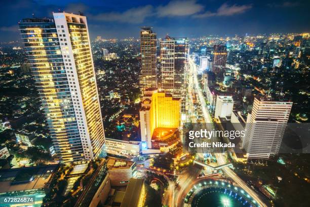 skyscrapers in jakarta, indonesia - indonesia bikes traffic stock pictures, royalty-free photos & images