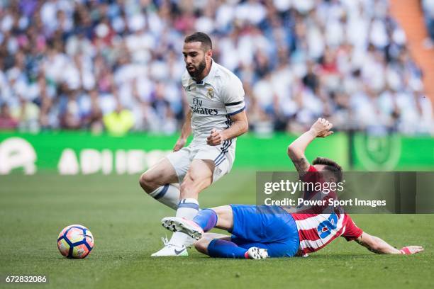 Daniel Carvajal Ramos of Real Madrid fights for the ball with Saul Niguez Esclapez of Atletico de Madrid during their La Liga match between Real...