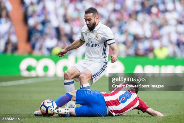 Daniel Carvajal Ramos of Real Madrid fights for the ball with Saul Niguez Esclapez of Atletico de Madrid during their La Liga match between Real...