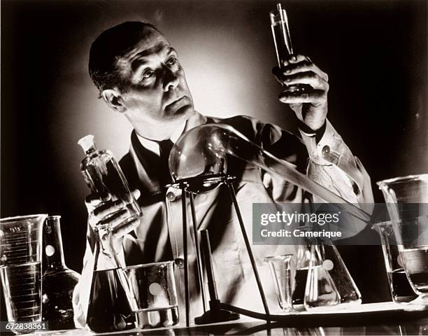Scientist Holding Up Test Tube Photos and Premium High Res Pictures ...
