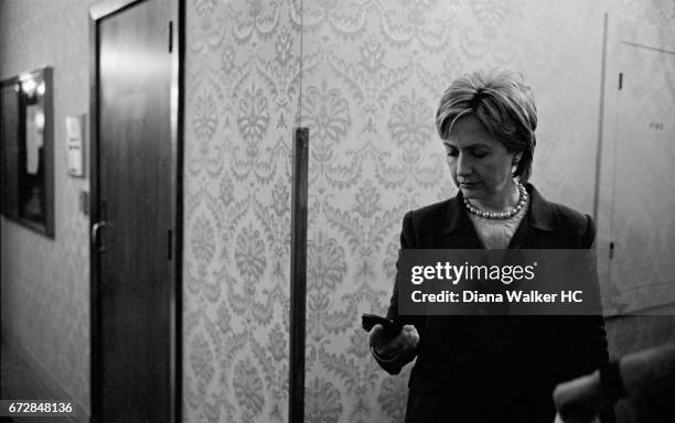 Senator Hillary Rodham Clinton is photographed checking her messages just before a meeting with labor leaders on January 27, 2007 at the Fort Des...