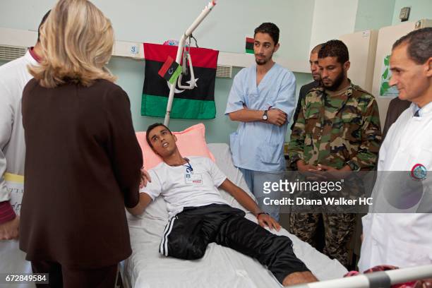 Secretary of State Hillary Rodham Clinton visits the bedside of a rebel amputee on October 18, 2011 at Tripoli Medical Center in Tripoli, Libya....