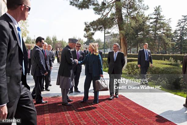 President Hamid Karzai of Afghanistan greets Secretary of State Hillary Rodham Clinton on October 20, 2011 outside the Presidential Palace in Kabul,...