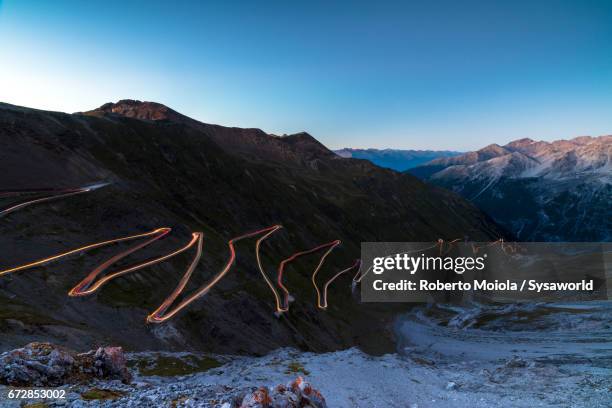 dusk lights on stelvio pass valtellina lombardy italy - stelvio pass stock pictures, royalty-free photos & images