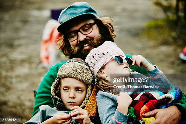 laughing father holding son and daughter - leanincollection father stock-fotos und bilder