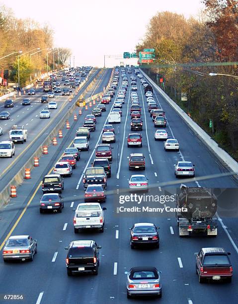 Slow moving vehicles drive eastward of the beltway, the section of the main highway that links the Washington, DC area to eastern states November 21,...