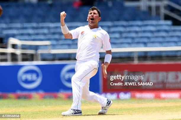 Pakistan's bowler Yasir Shah celebrates dismissing West Indies' Alzarri Joseph on the final day of the first Test match between West Indies and...