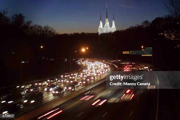 Slow moving vehicles drive eastward of the beltway, the section of the main highway that links the Washington, DC area to eastern states November 21,...