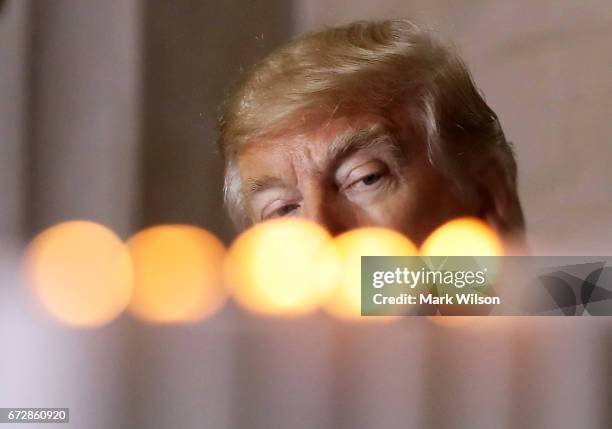 President Donald Trump watches as candles are lit during the U.S. Holocaust Memorial Museum's "Days of Remembrance" ceremony at the U.S. Capitol...