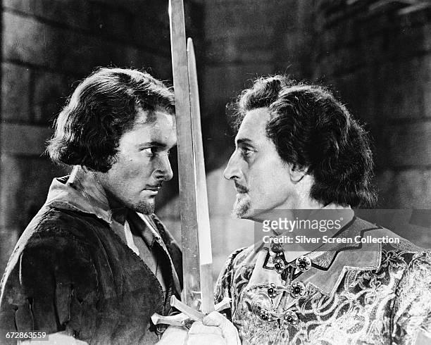 Tasmanian-born actor Errol Flynn as Robin Hood crosses swords with Basil Rathbone as the villainous Sir Guy of Gisbourne in the film 'The Adventures...