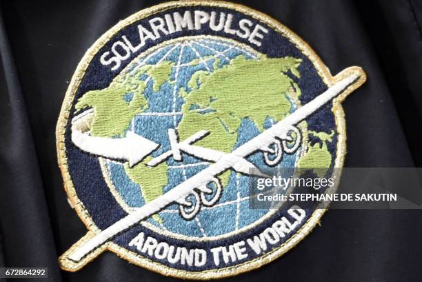 Picture taken on April 25, 2017 at the Elysee Palace in Paris shows an insigna of the Solar Impulse sun-powered aircraft during an awards ceremony...