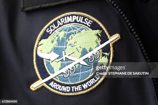 Picture taken on April 25, 2017 at the Elysee Palace in Paris shows an insigna of the Solar Impulse sun-powered aircraft during an awards ceremony...