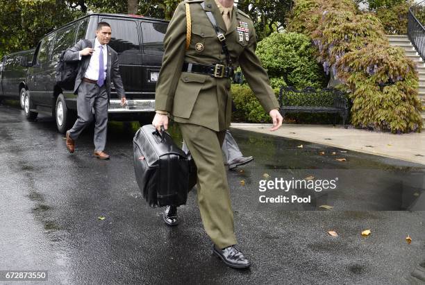 Military aide carries the "nuclear football" on the South Lawn of the White House on April 25, 2017 in Washington, DC.