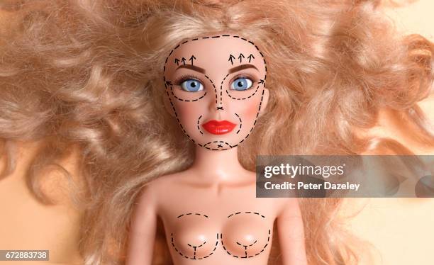 doll marked up for plastic surgery - muñeca barbie fotografías e imágenes de stock