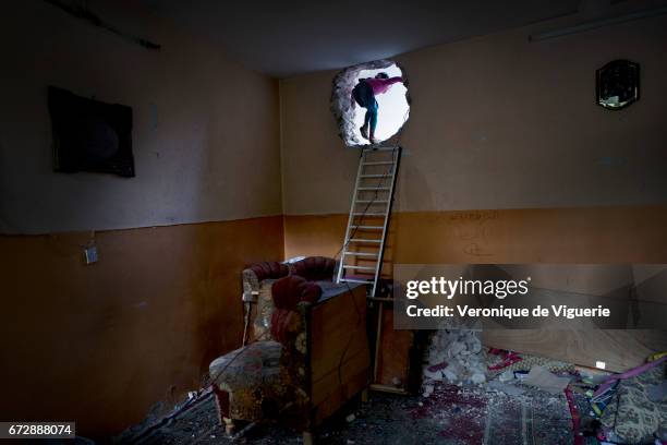 Rama and Abdul Wahab have to go through the holes made in their house walls to avoid snipers and stray bullets. They are living at the frontline,...