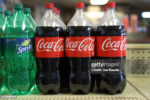 Coca Cola products are seen on a store shelf as the company announces plans to cut 1200 corporate staff jobs on April 25, 2017 in Miami, Florida. The...