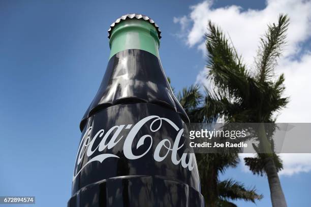 Giant Coca Cola bottle is seen in front of a distribution center as the company announces plans to cut 1200 corporate staff jobs on April 25, 2017 in...