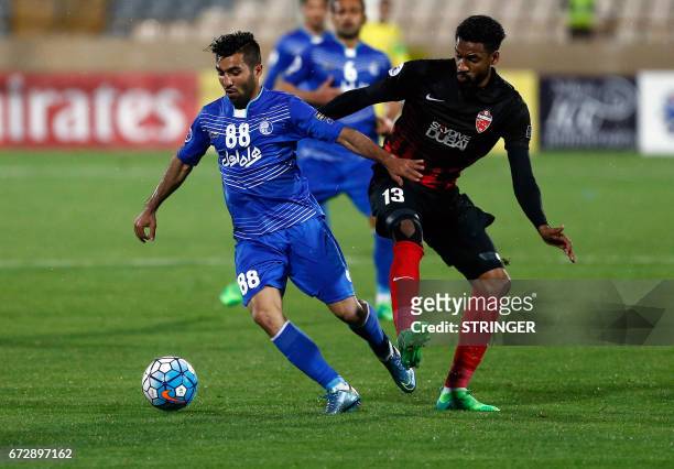 Esteghlal's Iranian midfielder Farshid Esmaeili dribbles past Al-Ahli's Emirati midfielder Khamis Esmaeel during their AFC Champions League group B...